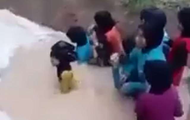 Disturbing VIDEO shows men terrorizing young girls by forcing them into python pit
